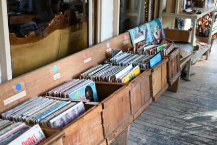 Wooden crates of vinyl records lined along the porch
