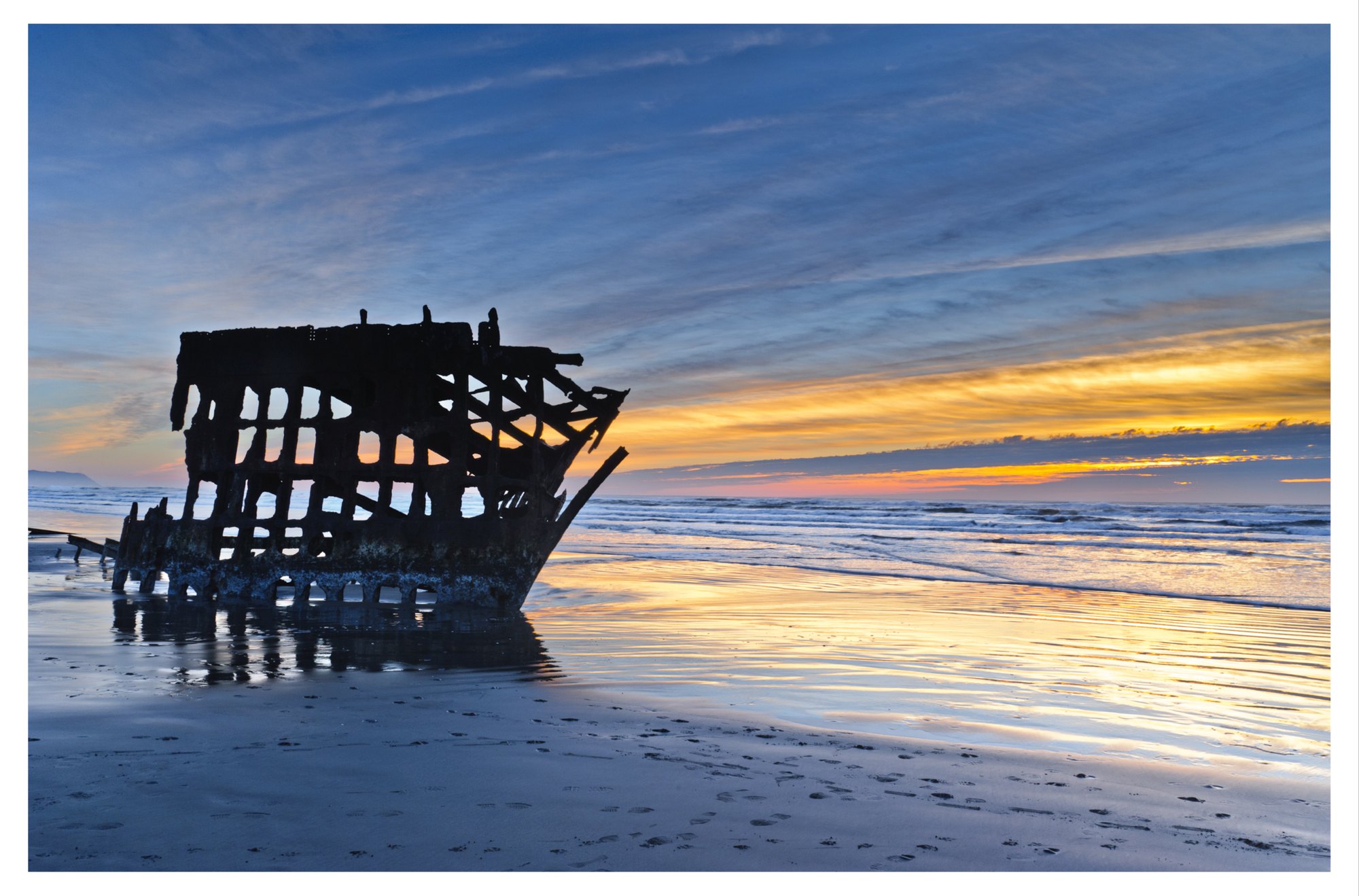 The wreck of the Peter Iredale on the beach at Fort Stevens State Park at sunset